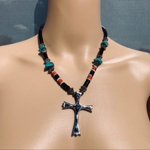 Inlayed turquoise, coral and onyx cross necklace.